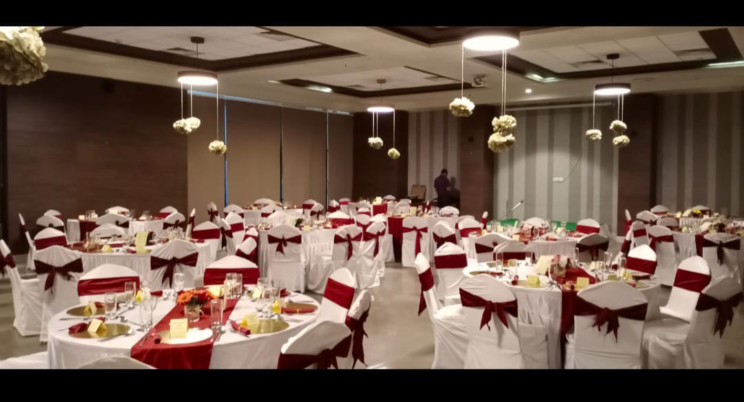 The ballroom dressed for an evening reception with the terrace doors open.