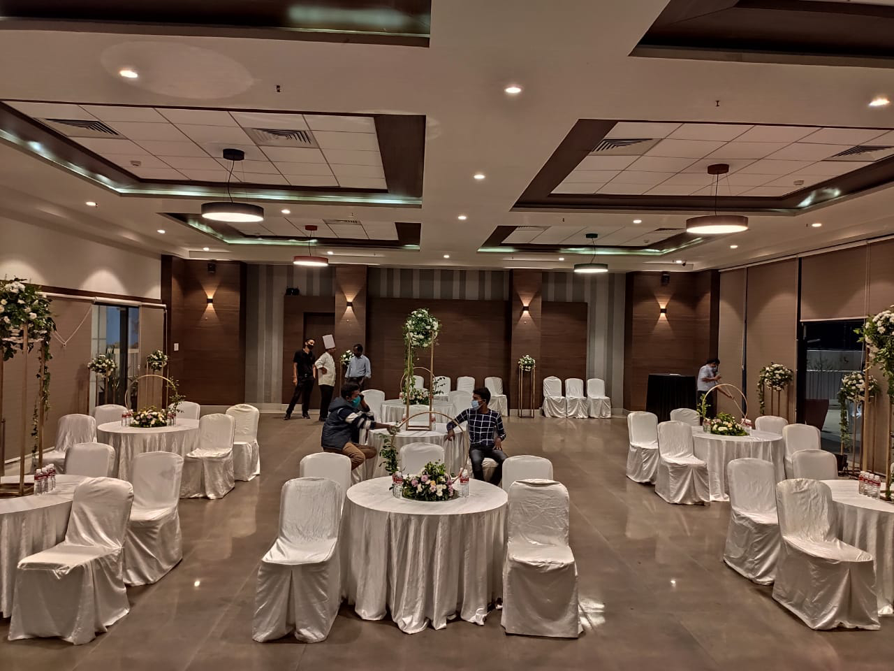 The ballroom set up in conference layout with a projector screen for a daytime corporate session.